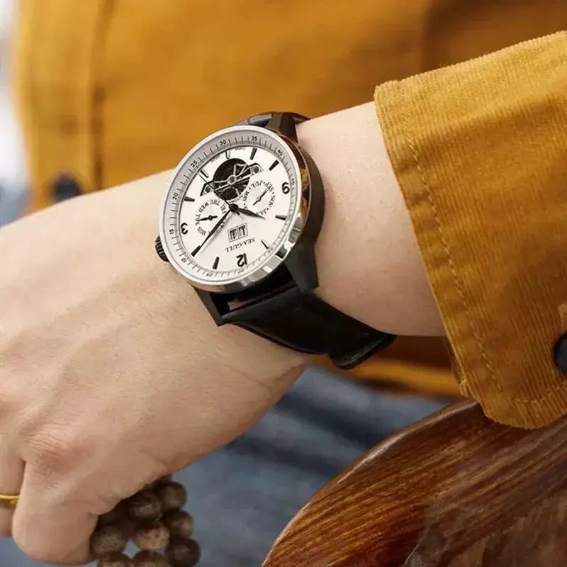 Seagull men's automatic wristwatch with skeleton flywheel, white dial, black strap, calendar subdials, water resistant