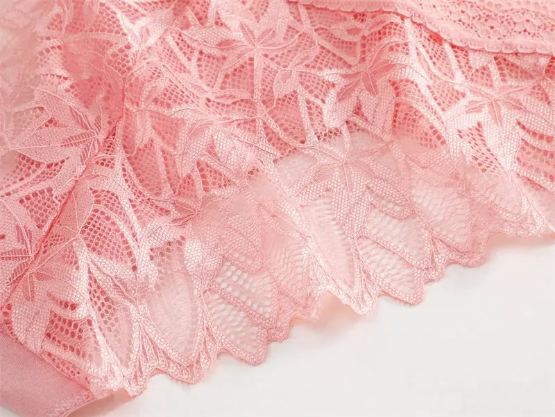 Lace underwear fabric in pink with floral pattern and scalloped edge.