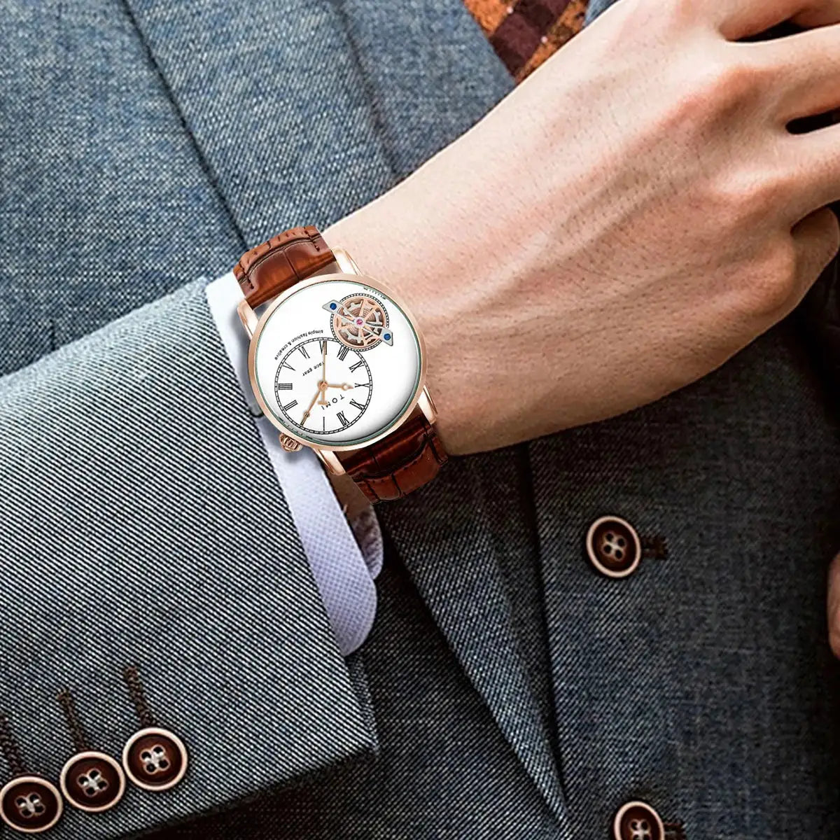 TOMI men's quartz watch with brown leather strap and skeleton dial on a suited wrist