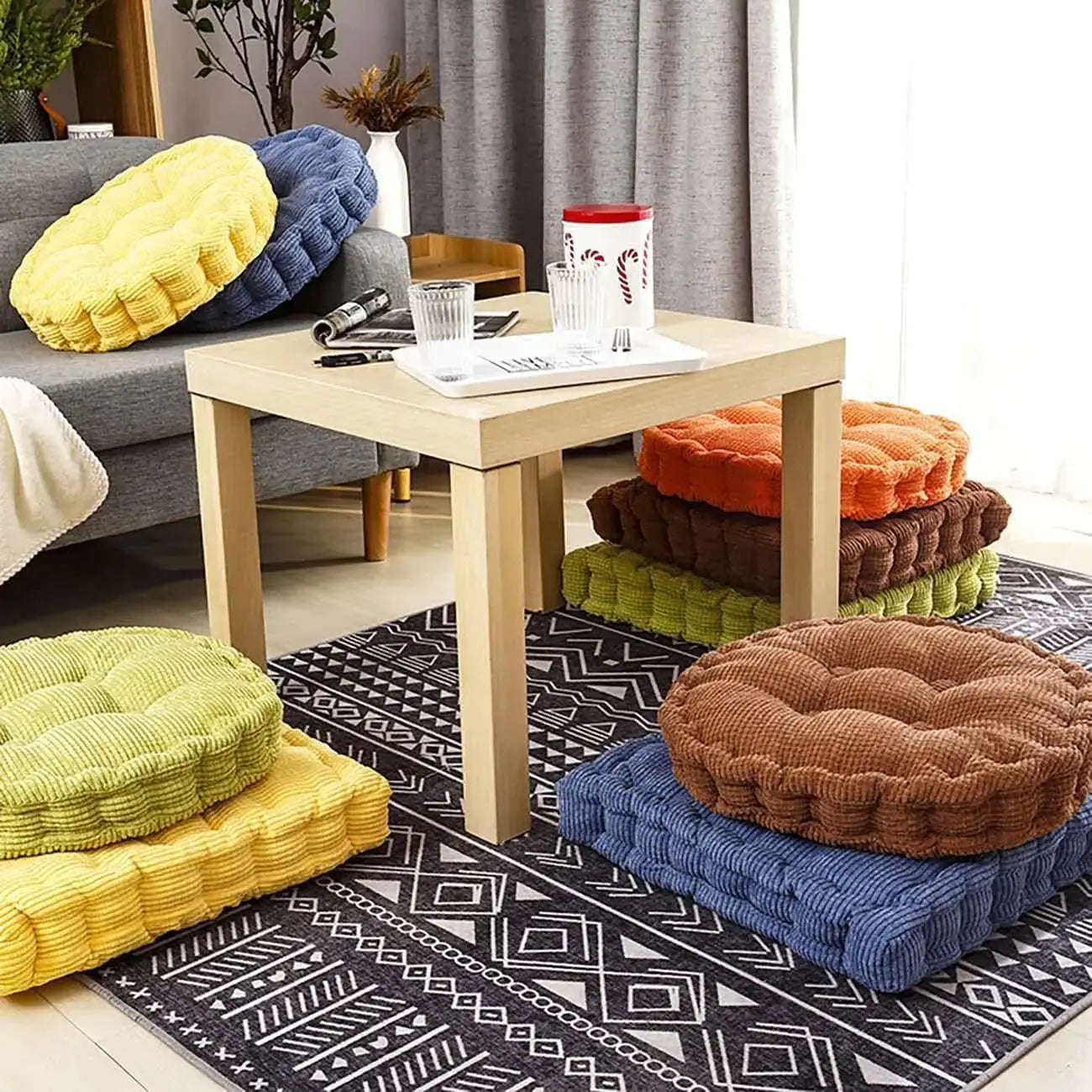 Tufted seat cushions, 50x50cm, five thick round pads in yellow, blue, orange, brown and green.