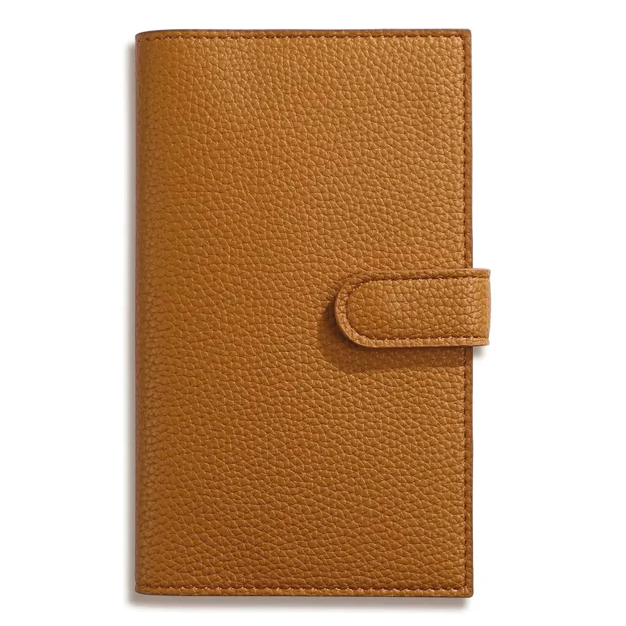 A6 weekly planner notebook with compact tan leather cover and strap closure