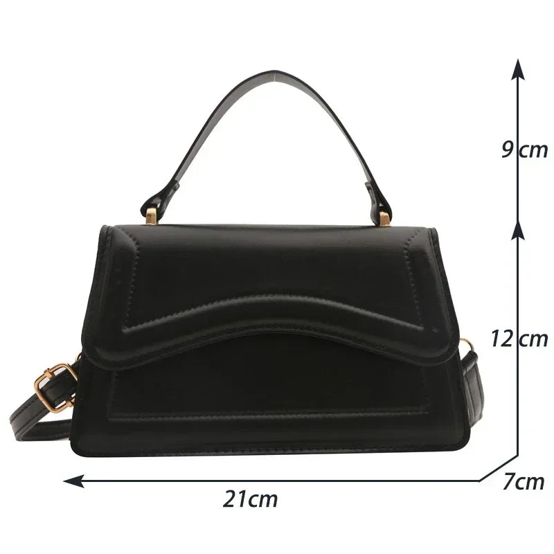 PU leather handbag by Simples Market in black with top handle and crossbody strap