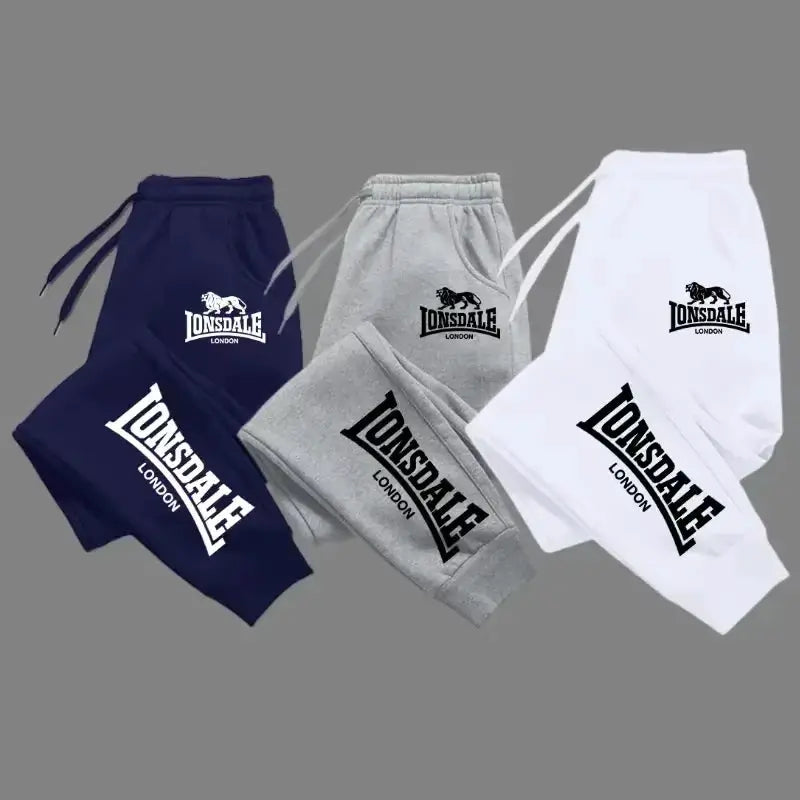 Lonsdale London jogger pants in navy, grey, and white with bold logo on leg