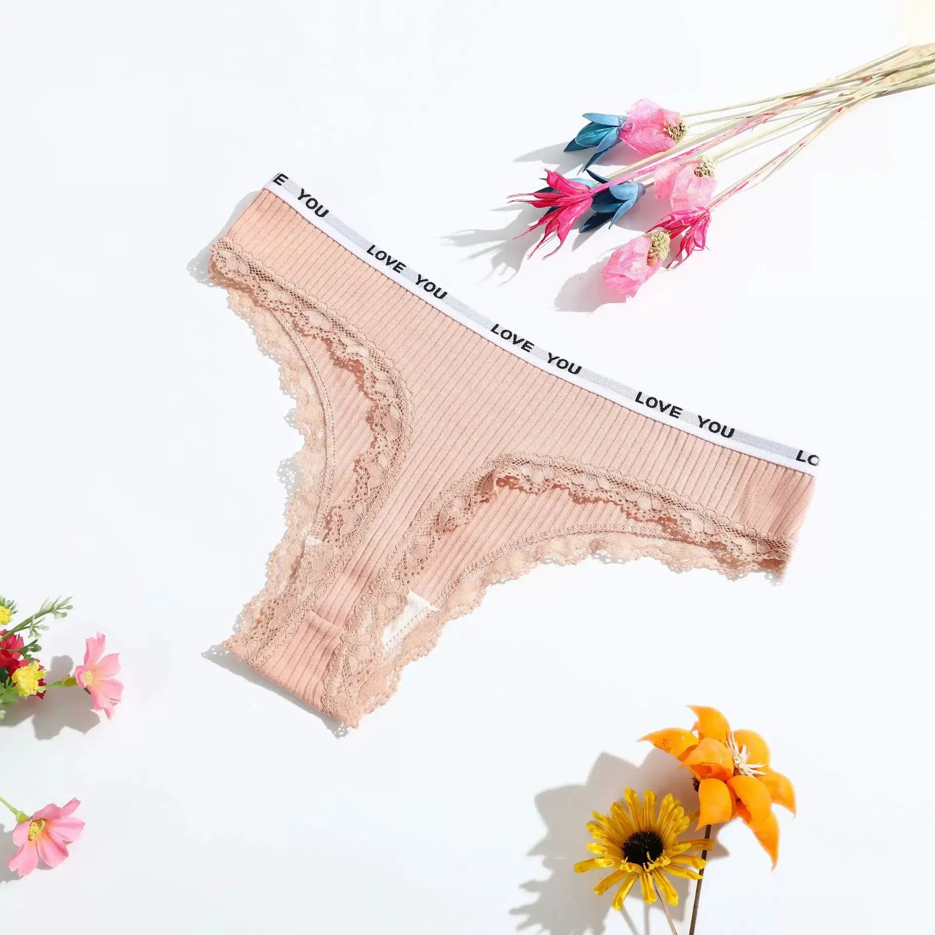 Lace thong underwear in nude beige with lace trim and white waistband featuring LOVE YOU print.