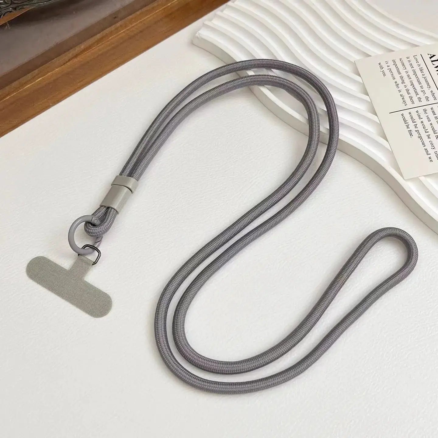 Mobile phone lanyard in solid gray nylon rope with double cords, metal ring, and T-shaped pendant