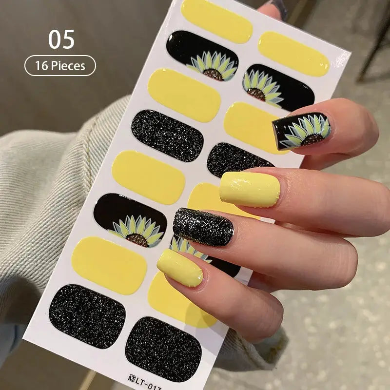 Full-cover nail stickers sheet with yellow and black glitter designs and sunflower accents, 16 pieces