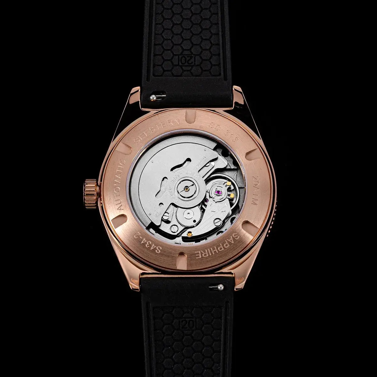 SEESTERN diver watch with rose-gold case, transparent caseback showing NH35A automatic movement, black rubber strap.