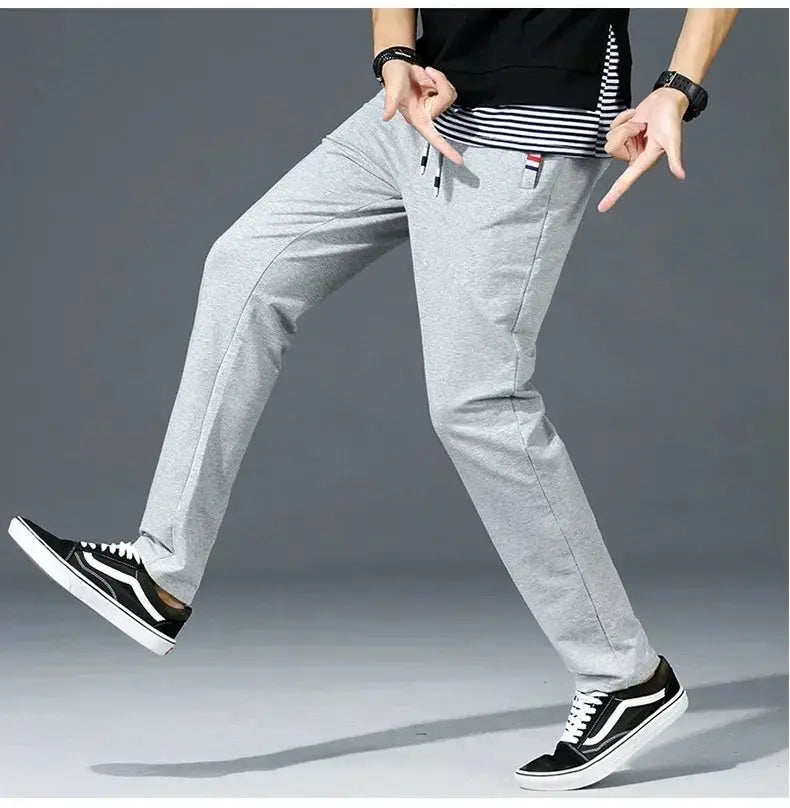 Men's gray cotton jogger pants with elastic waistband and drawstring, loose fit