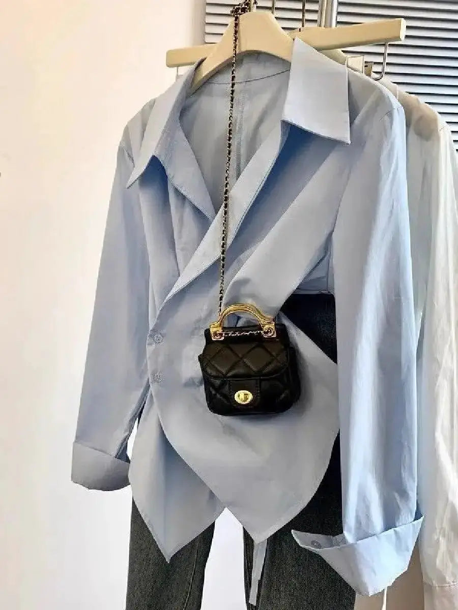 Light blue irregular wrap blouse for women with long sleeves, paired with a small black quilted bag (2-piece set)