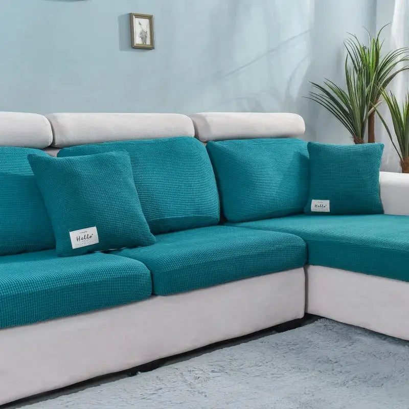 Thick elastic sofa cover set in teal blue for L-shaped sectional sofa by Simples Market