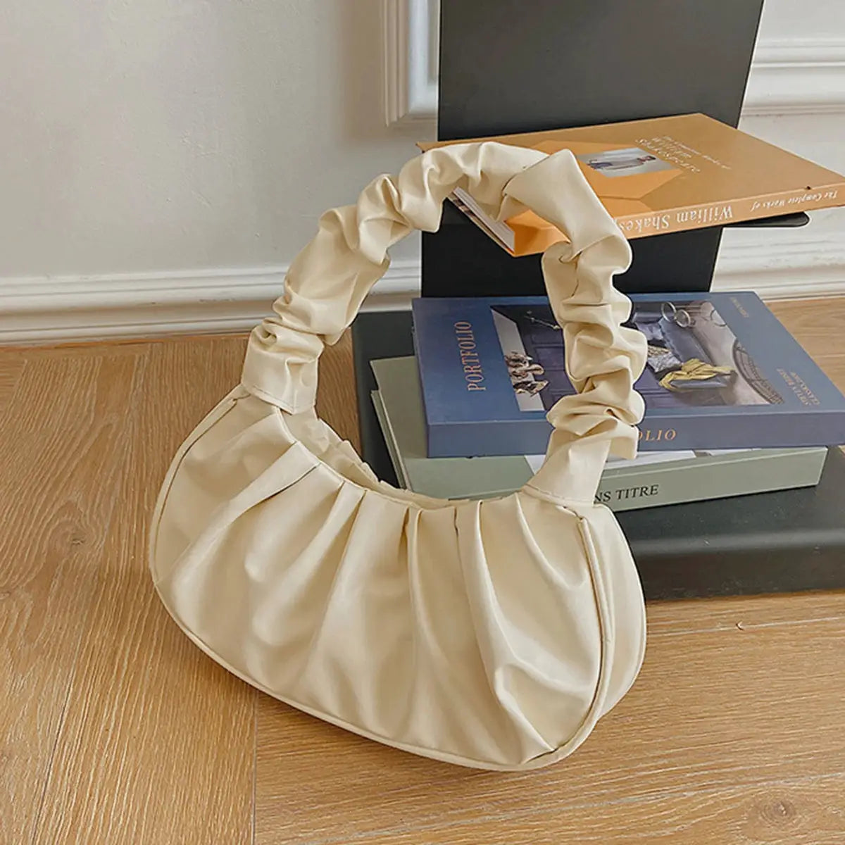 Beige PU dumpling handbag with gathered pleated handle by Simples Market