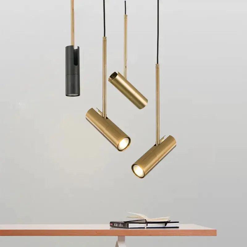 Minimalist LED pendant lights by Simples Market; gold cylindrical tubes, set of 4, hanging over table