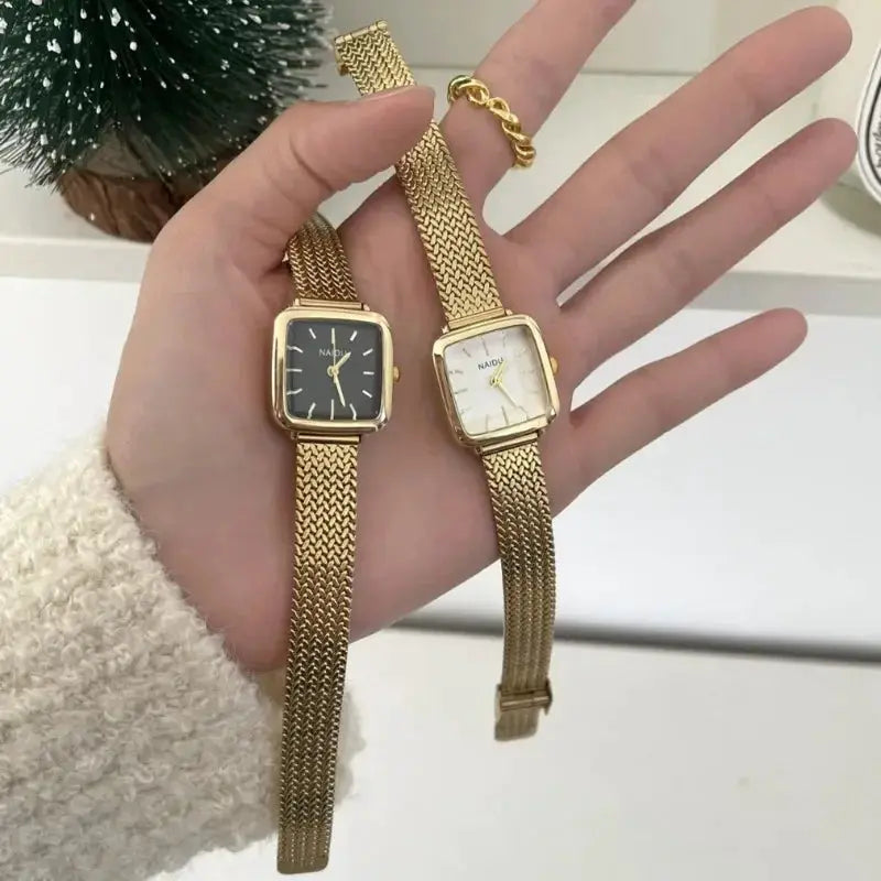 Gold-tone women's square-dial quartz watches set; two mesh stainless steel bands with black and white dials.