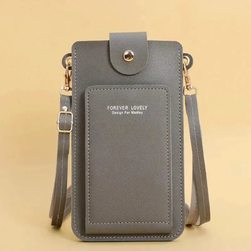 Women's soft gray leather crossbody bag with front stitched pocket, detachable shoulder strap, and gold-tone hardware