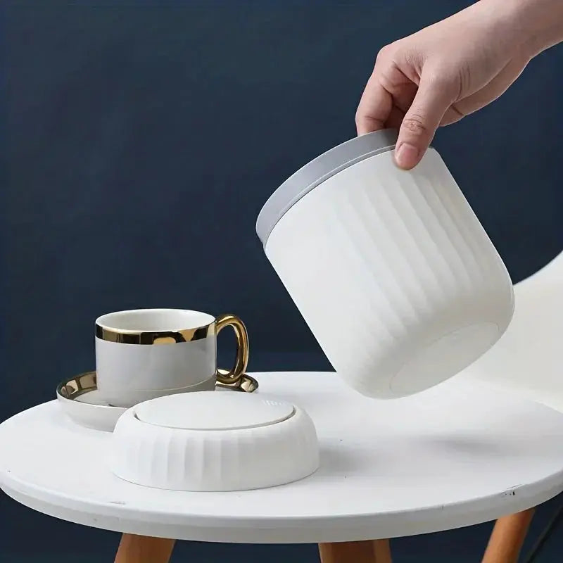 Simples Market mini desktop trash can with lid, white ribbed plastic on a white round table.