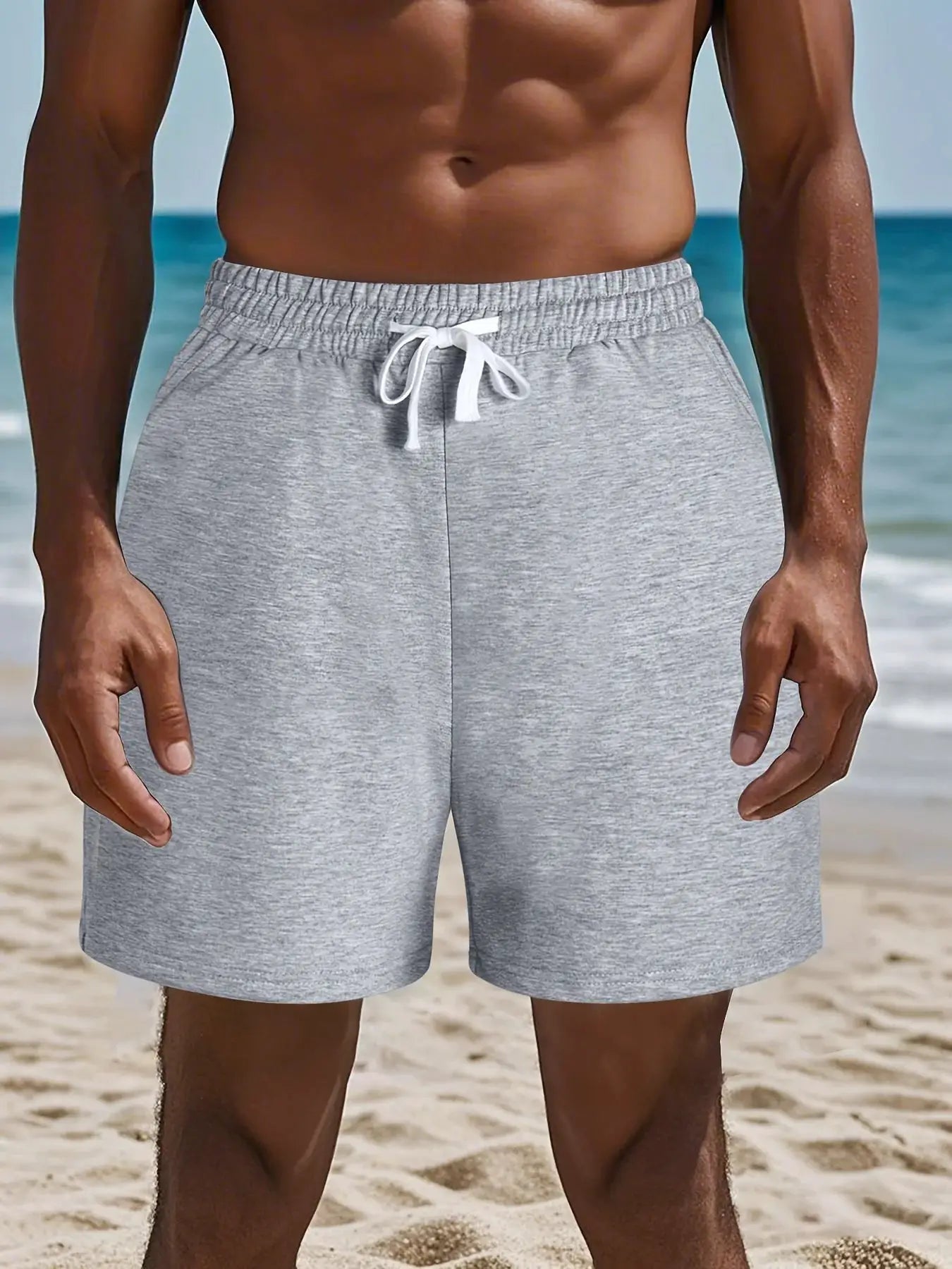 Men's gray cotton shorts with white drawstring at the beach