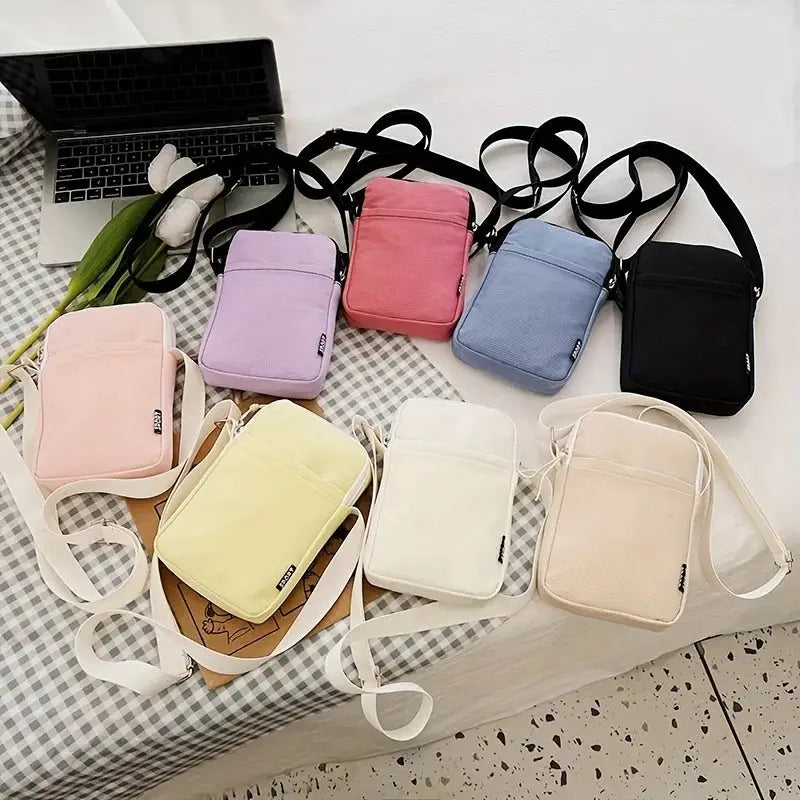 Shoulder messenger bags by Simples Market, set of nine in pastel colors with crossbody straps.