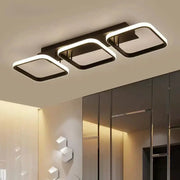 LED ceiling light with three connected rounded-square frames, black metal and white LED edge lighting, Simples Market.