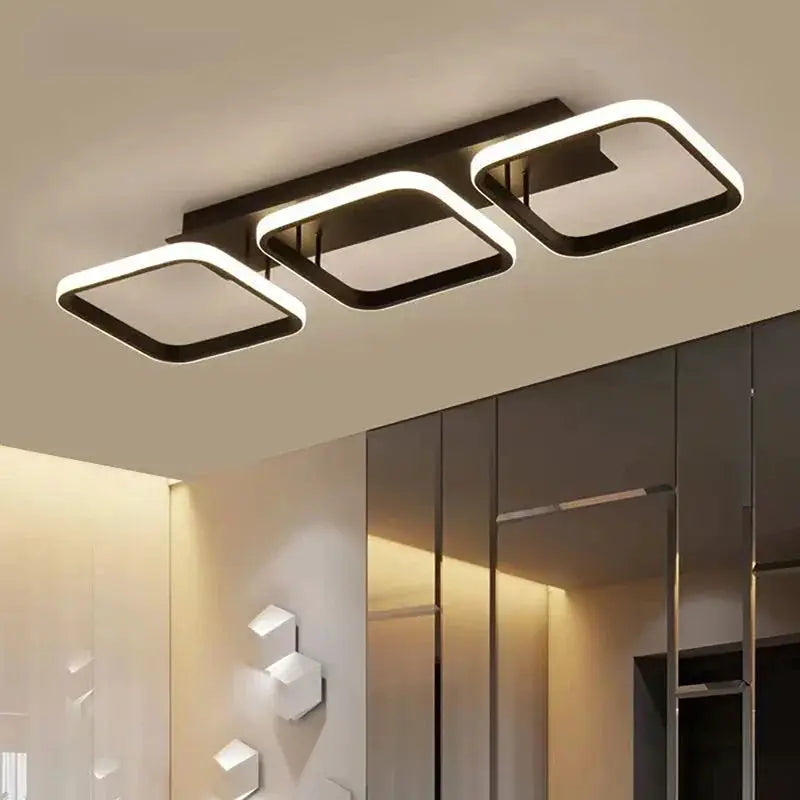 LED ceiling light with three connected rounded-square frames, black metal and white LED edge lighting, Simples Market.