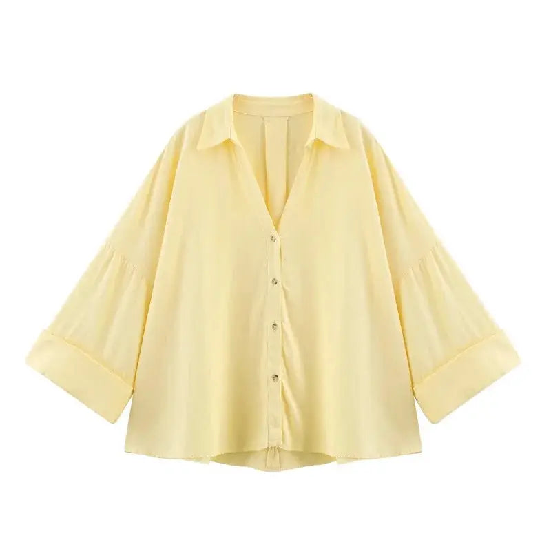 Women's pale yellow button-up blouse with wide, cuffed sleeves by Simples Market