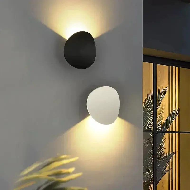 Simples Market outdoor LED wall lamp pair, black and white circular sconces with warm upward and downward light.
