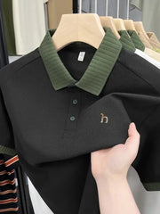 Polo shirt black with green rib collar by Simples Market featuring small dog embroidery.