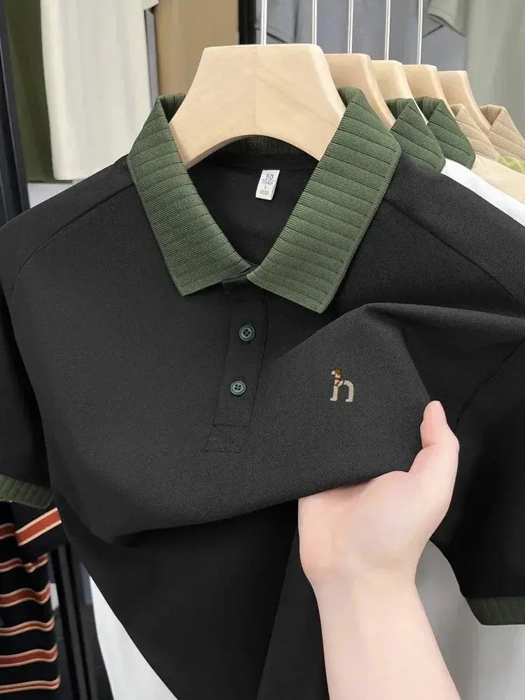Polo shirt black with green rib collar by Simples Market featuring small dog embroidery.