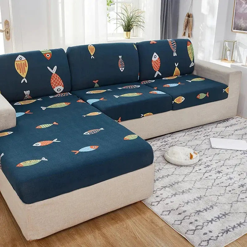 Elastic seat cushion covers in navy blue with colorful fish pattern on a beige sectional sofa