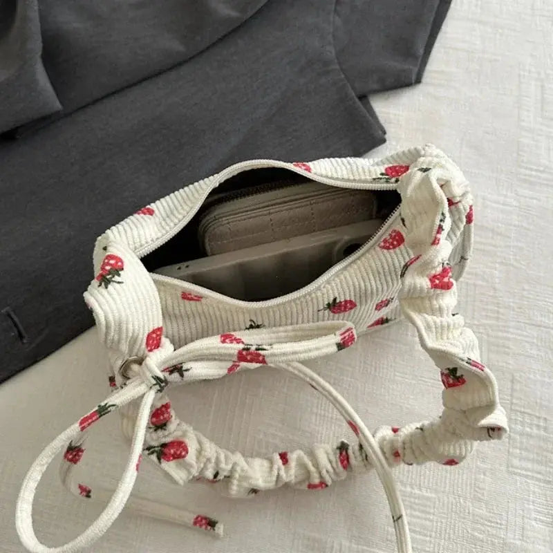 Corduroy underarm bag by Simples Market with strawberry print, cream mini half-moon purse