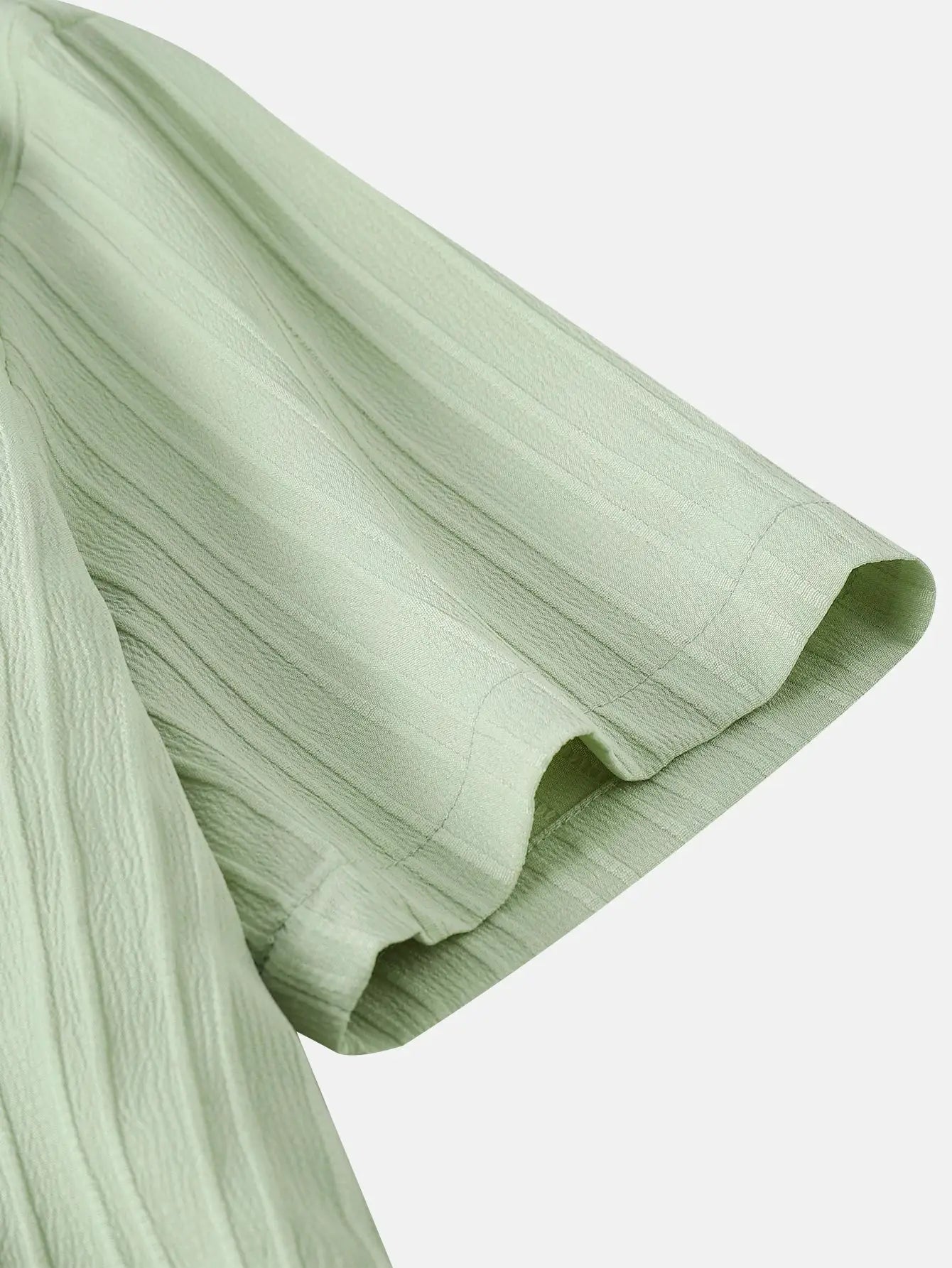 Men's short sleeve shirt in mint green with textured solid-color fabric close-up