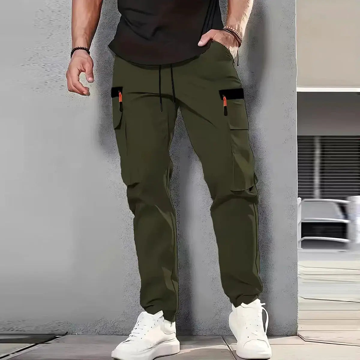Men's olive green cargo pants with multiple pockets, drawstring waist, straight-leg fit