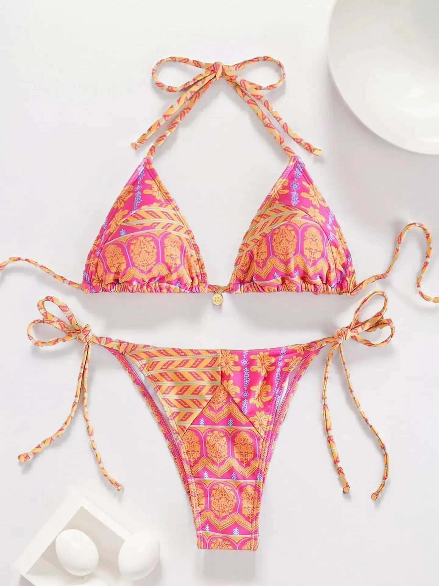 Simples Market two-piece bikini set, pink-orange tropical print triangle top with adjustable tie sides.