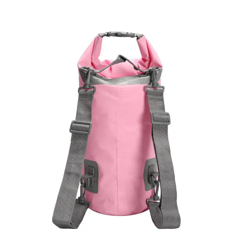 Simples Market pink PVC waterproof dry bag with dual grey shoulder straps and roll-top closure.