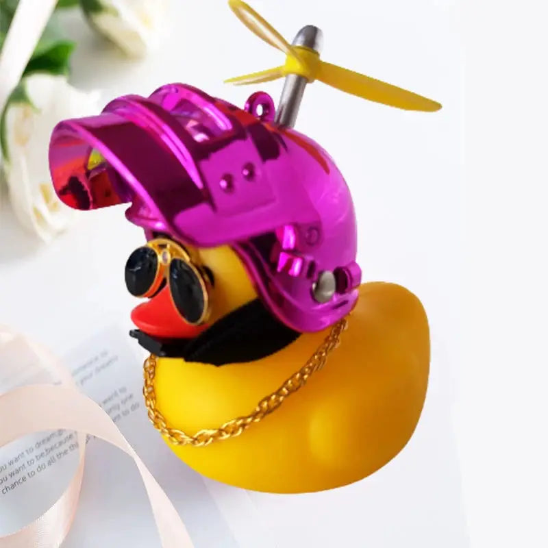 Yellow rubber duck by Simples Market for car interior decoration, wearing a purple helmet with propeller, sunglasses, and a gold chain