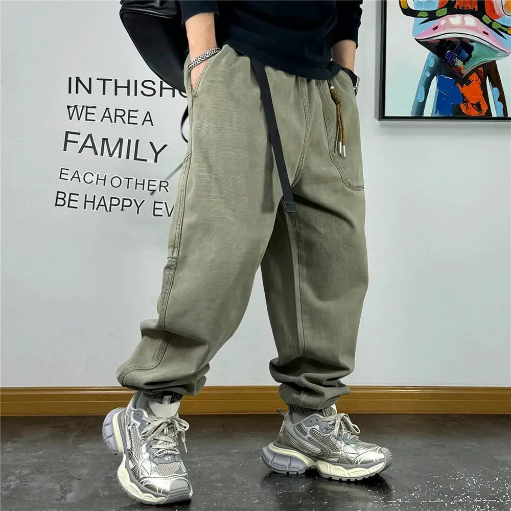Baggy cargo pants in olive green with oversized pockets, drawstring waist, and cuffed ankles, Harajuku streetwear style