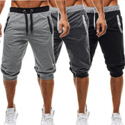 Simples Market men's seven-quarter jogger pants in grey, charcoal, black; three pairs with drawstring waist.