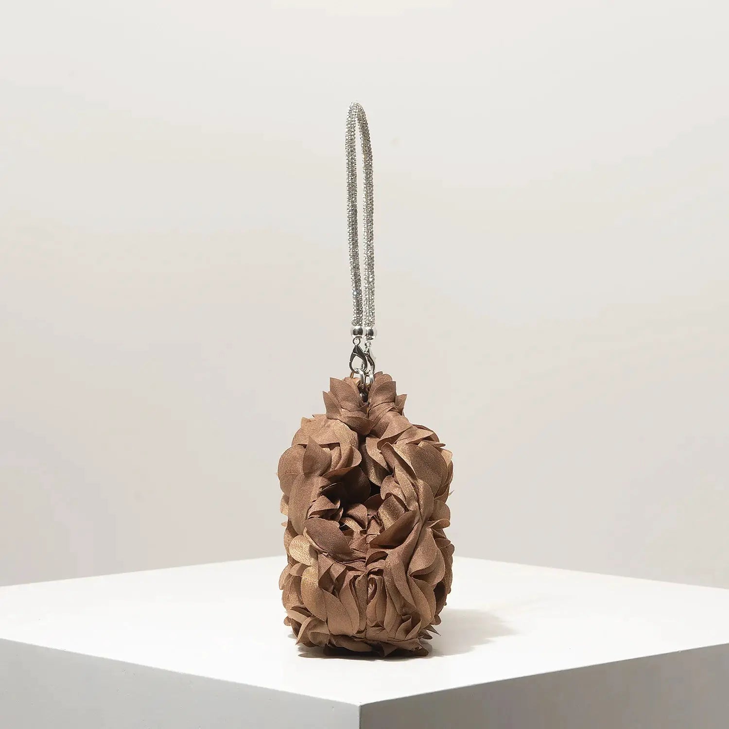 Mini floral purse with brown rosette petals and a silver beaded strap.
