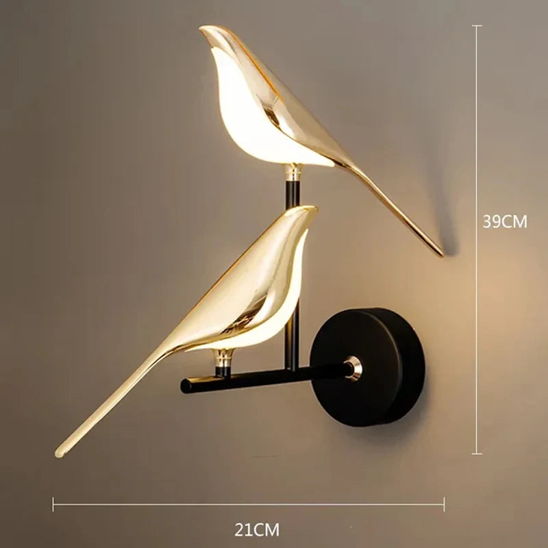 Modern LED wall lamp featuring two gold-tone magpie bird sculptures on a black wall mount