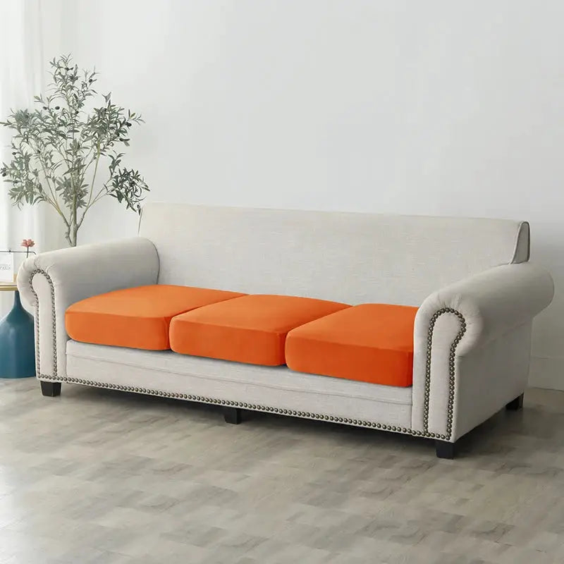 Simples Market plush sofa slipcover on gray sofa with 3 orange seat cushions