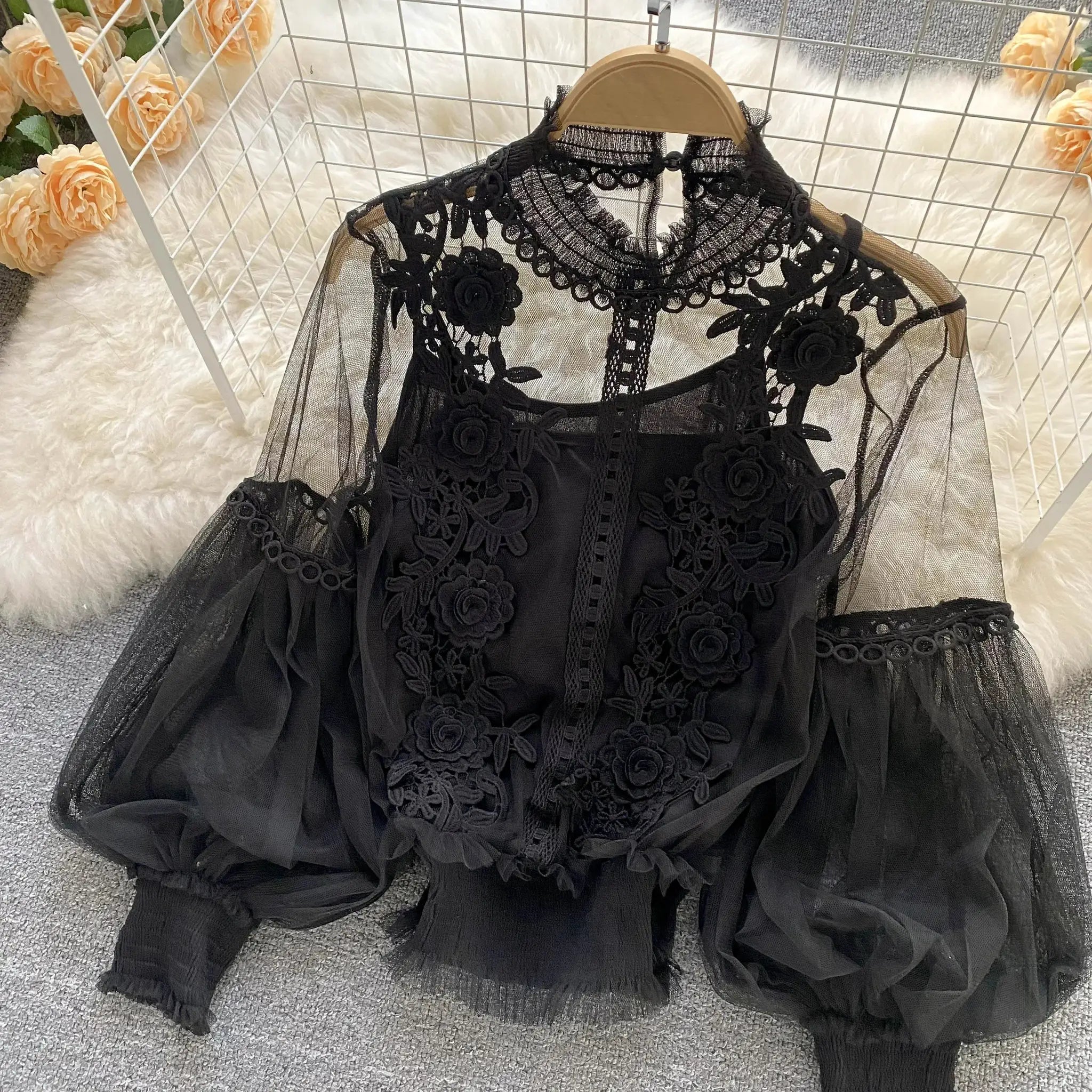 Lace puff long-sleeve blouse in black with sheer mesh and floral appliqué details.