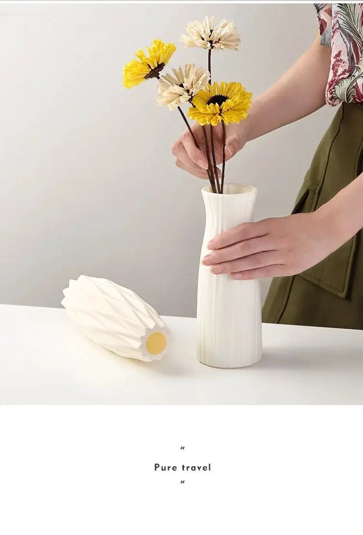 Nordic white ribbed plastic vase with a small bouquet of yellow and beige flowers