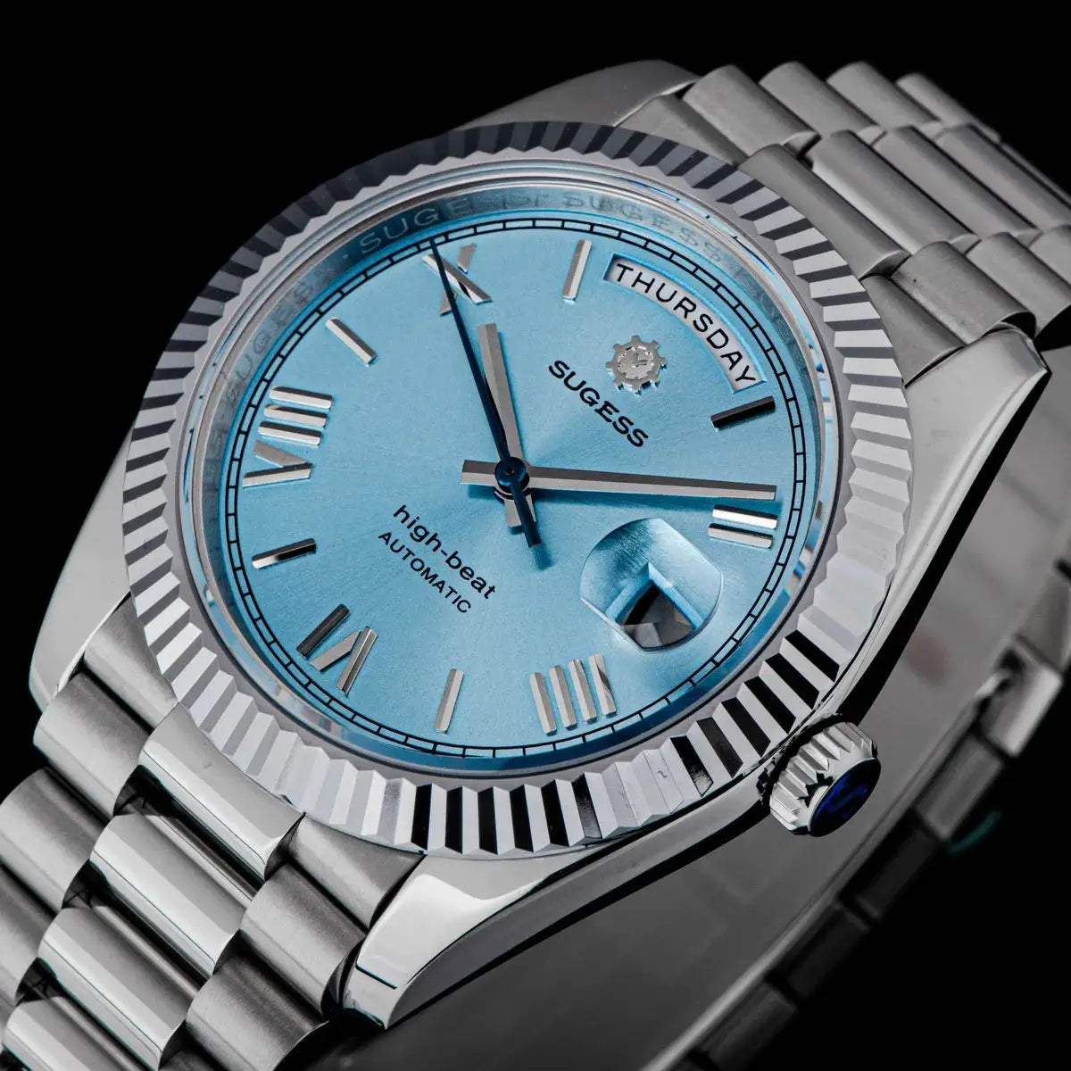 Sugess men's 40mm automatic watch with blue dial, day-date window, and stainless steel bracelet.