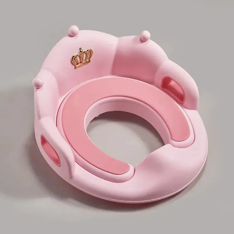 Baby and Child Toilet Seat Ring, pink cushioned design with crown emblem, by Simples Market.