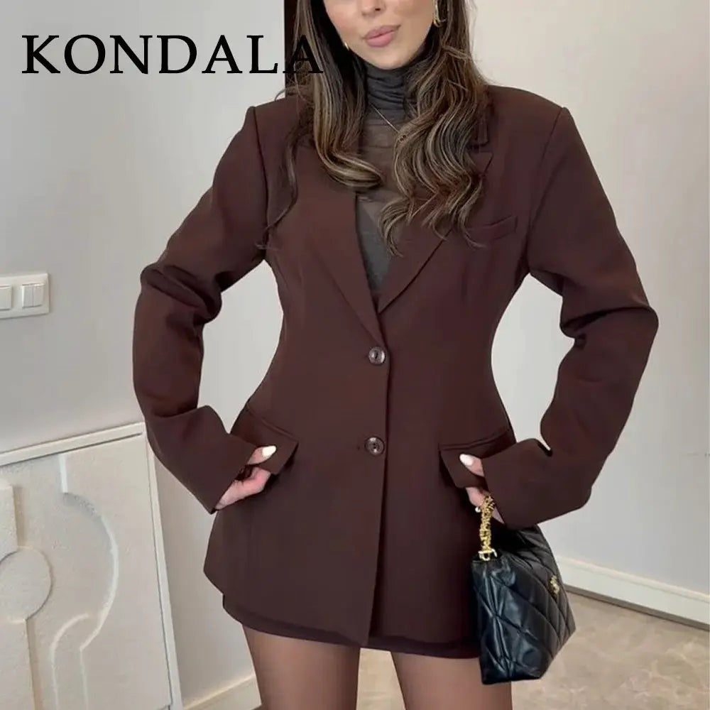 KONDALA brown blazer set with pockets, matching shorts, and a black quilted handbag