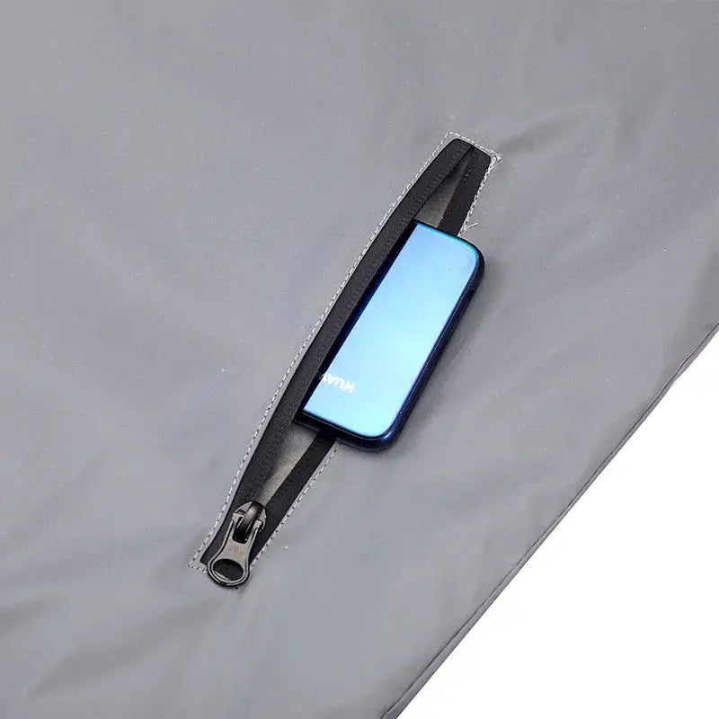 Night reflective vest for men, gray lightweight fabric with zip pocket holding Huawei phone.