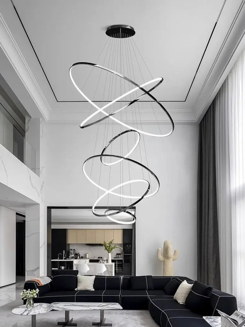 Spiral LED pendant light by Simples Market, black metal circular rings, modern living room chandelier.