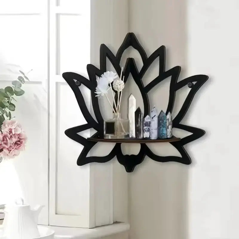 Wooden lotus hollow wall-mounted shelf in black with crystal obelisks and diffuser on a small wooden ledge.