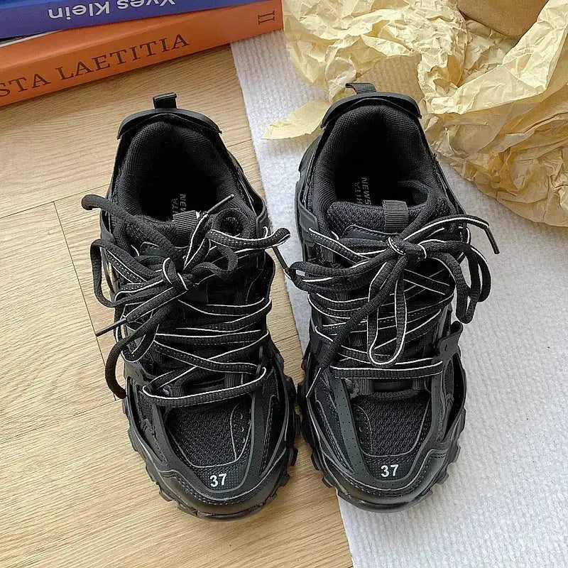 Pair of black chunky sneakers with laces and rugged sole, size 37.