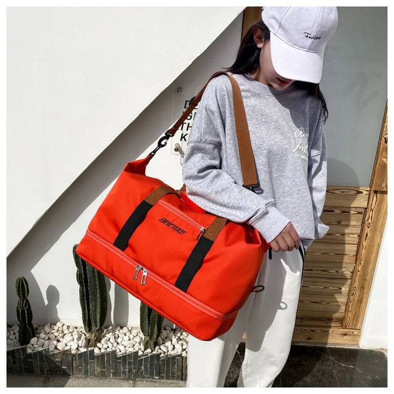 Orange large-capacity travel gym bag with brown shoulder strap and front zip pocket
