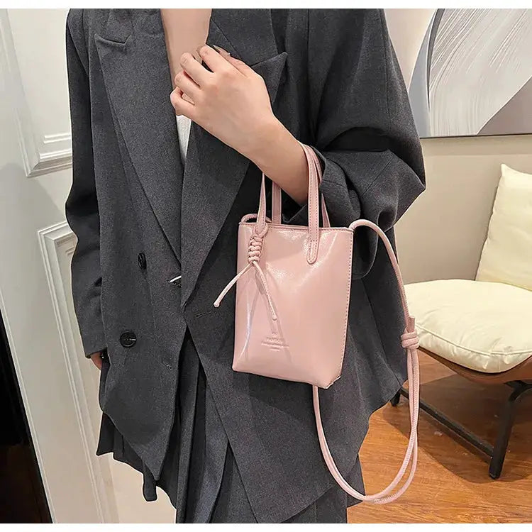 PU leather mini crossbody bag in light pink with top handles and adjustable strap